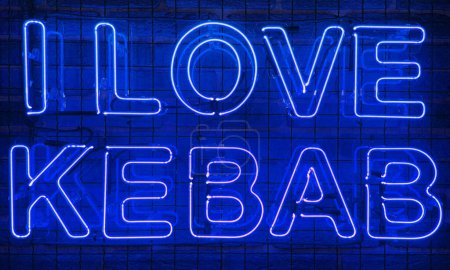 Neon shining sign in blue color on a brick wall with the inscription or slogan I love kebab. Brick wall, background. Bright electric neon light. Cafe-restaurant Doner Kebab