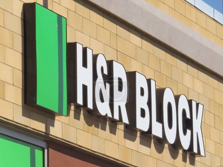 Photo for Calgary, Alberta, Canada. Apr 30, 2023. A side view of a H and R Block location sign. Concept: Tax Season - Royalty Free Image