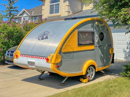 Photo for Calgary, Alberta, Canada. Jun 6, 2023.A Teardrop Camping Trailer parked in front of a house. - Royalty Free Image