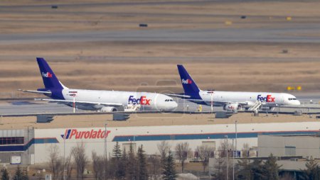 Photo for Calgary, Alberta, Canada. Mar 17, 2024. A couple of FedEx planes at the Calgary Airport. - Royalty Free Image