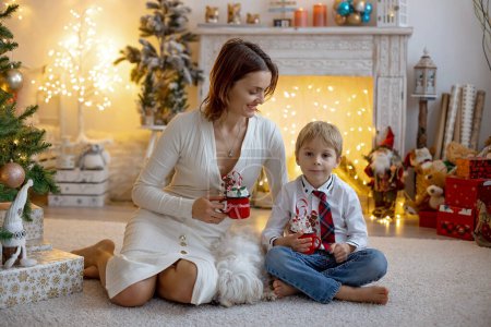 Photo for Mom and child, cute blond boy, sitting at home in cozy armchair, enjoying quality family time  together - Royalty Free Image
