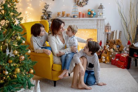 Photo for Christmas family picture in cozy home with lights and decoration, grandmother, mother and children - Royalty Free Image