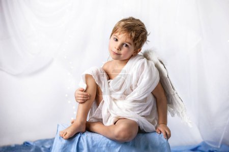 Photo for Little cupid toddle boy, holding bow and arrow, beautiful blond cherub, love - Royalty Free Image