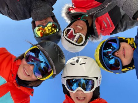 Photo for Happy family, skiing in Italy on a sunny day, kids and adults skiing together - Royalty Free Image