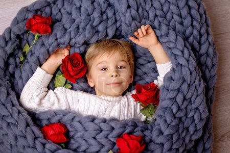 Foto de Valentine portrait of a little cute child with hearts, roses and sign - Imagen libre de derechos