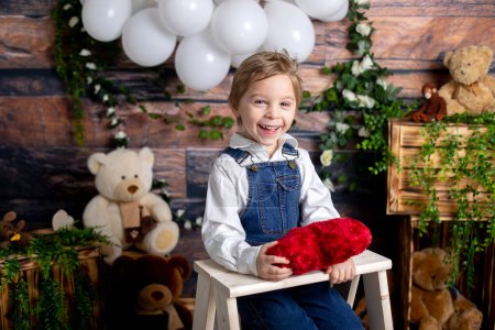 Foto de Valentine portrait of a little cute child with hearts, roses and sign - Imagen libre de derechos