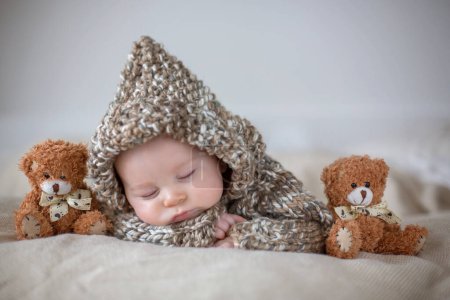 Photo for Little baby boy , sleeping at home with soft teddy bear toys, lying down - Royalty Free Image