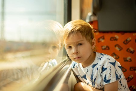 Téléchargez les photos : Mignon petit enfant, garçon, voyager dans un train, l'été - en image libre de droit