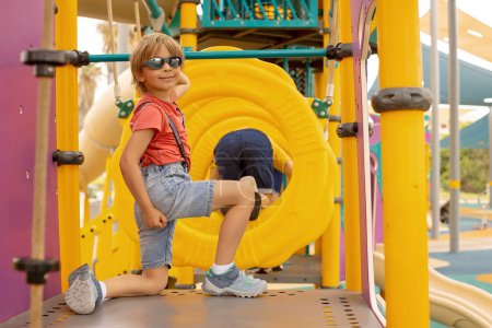 Photo for Happy children, boys, playing on playground in Tel Aviv, israel on a hot summer day - Royalty Free Image