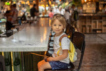 Photo for Family with kids, enjoying the Sarona Market in Tel Aviv, Israel, trying the food - Royalty Free Image