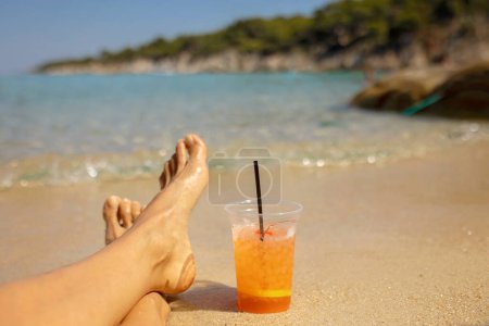 Photo for Woman on the beach, drinking coctail in the water, enjoying summer. Halkidiki, Greece - Royalty Free Image