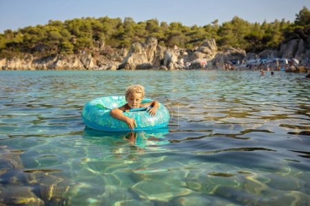 Foto de Happy child on the beach, enjoying summer, playing. Greece, Halkidiki - Imagen libre de derechos