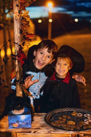 Photo for Children, celebrating Halloween outdoors at night, dracula, vampire, mummy,  pumpkins, happy kids - Royalty Free Image