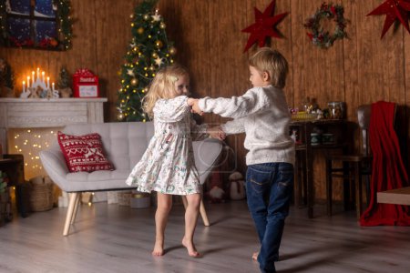 Photo for Beautiful children, blond kids, siblings, playing in decorated home for Christmas, enjoying holidays at home - Royalty Free Image