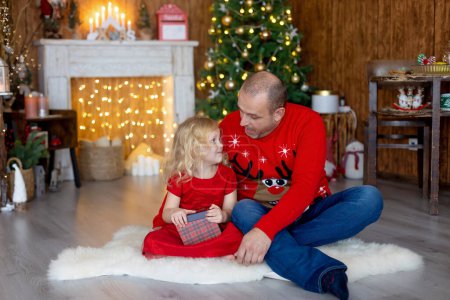 Photo for Happy family on Christmas at home, enjoying quality time together - Royalty Free Image