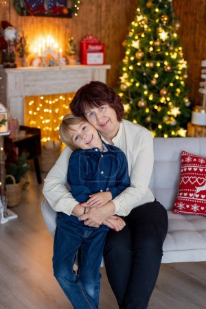 Photo for Grandmother and child at home on christmas, reading, writing letter, baking, enjoying the xmas holidays - Royalty Free Image