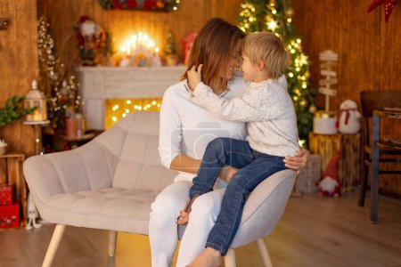 Photo for Happy family with kids on Christmas at home, enjoying quality time together as a family - Royalty Free Image