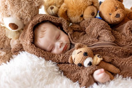 Téléchargez les photos : Doux nouveau garçon enfant, bébé garçon dans l'ours en général, dormir au lit avec des ours en peluche - en image libre de droit