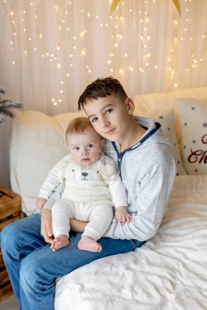 Photo for Happy family, newborn baby and older brothers, mom at home on Christmas - Royalty Free Image