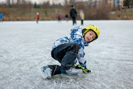 Photo for Happy child, boy, skating during the day on frozen lake, having fun outdoors - Royalty Free Image