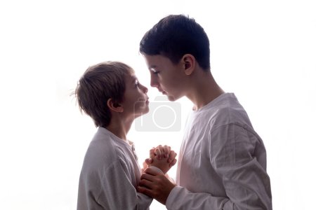 Photo for Isolated portrait on white background of siblings in studio, boys, holding hands - Royalty Free Image