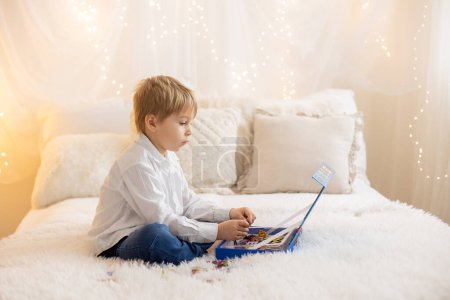 Photo for Cute little preschool child, playing with alphabet game, learning letters and words at home, preparing for school - Royalty Free Image