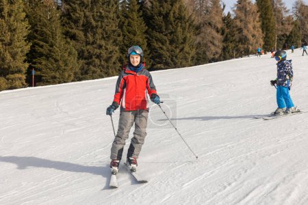 Photo for Children and adults, happy family in winter clothing at ski vacation, skiing, wintertime - Royalty Free Image