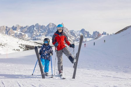 Photo for Children and adults, happy family in winter clothing at ski vacation, skiing, wintertime - Royalty Free Image