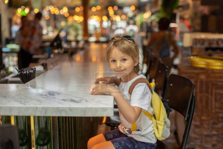 Photo for Family with kids, enjoying the Sarona Market in Tel Aviv, Israel, trying the food - Royalty Free Image