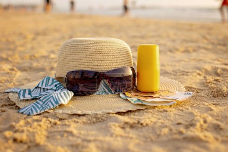 Vacation time - straw hat, sunglasses, suncream and money, ready for a holiday Tel Aviv, Israel