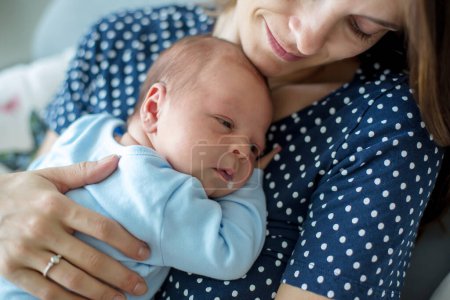 Photo for Young mother, holding tenderly her newborn baby boy, close portrait - Royalty Free Image
