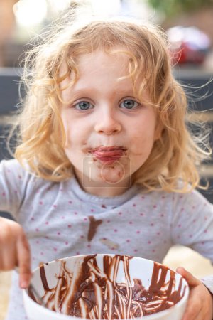 Photo for Children, kids, siblings, eating chocolate ice cream spring time, outdoors - Royalty Free Image