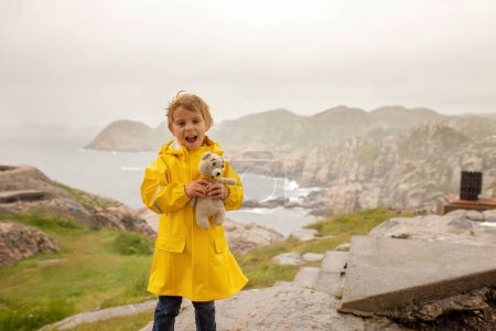 Family with children, visiting the Lindesnes Fyr Lighthouse in Norway on a rainy cold day