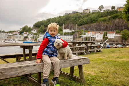 Child, visiting little town in south Norway, Arendal, on a rainy summer day, enjoying splendid views