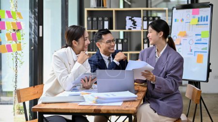 Photo for Team of millennial Asian businesspeople or accountants working together, having a good conversation during work, sharing ideas and brainstorming. - Royalty Free Image