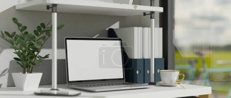 Photo for Modern offie desk workspace near the window with notebook laptop blank screen mockup, decor plant, coffee cup, and office supplies. 3d rendering, 3d illustration - Royalty Free Image