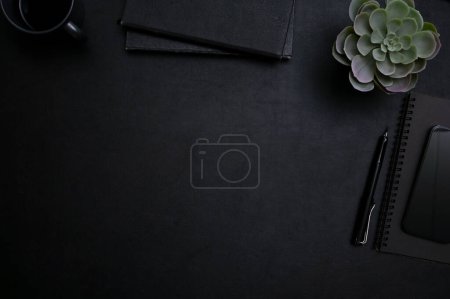Photo for Top view, flat lay, Black workspace with copy space for display your text, pen, notebooks and decor plant. - Royalty Free Image