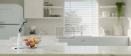 Photo for Empty space on kitchen tabletop with apple bowl and ceramic flower vase over blurred background of minimal white kitchen room. 3d render, 3d illustration - Royalty Free Image