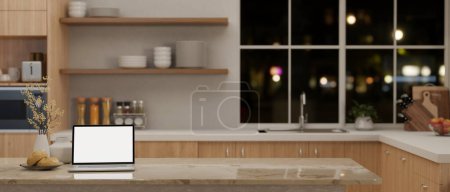 Téléchargez les photos : Un ordinateur portable écran blanc maquette sur un îlot de cuisine en marbre ou un comptoir dans une cuisine scandinave minimale moderne. Concept d'espace de travail à domicile. 3d rendu, illustration 3d - en image libre de droit