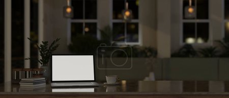 Téléchargez les photos : Un écran blanc pour ordinateur portable, une tasse à café, des livres et un espace de copie sur une table dans une chambre moderne et confortable la nuit. 3d rendu, illustration 3d - en image libre de droit