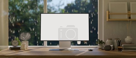 Foto de Espacio de trabajo en casa con un escritorio de computadora contra la ventana en un día lluvioso, una maqueta de computadora de pantalla blanca y accesorios en una mesa de madera. 3d render, ilustración 3d - Imagen libre de derechos