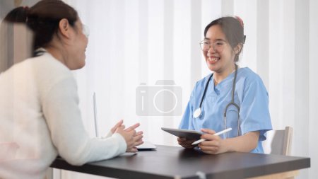 Photo for A professional and confident Asian female doctor is consulting a treatment plan with a female patient in the office at the hospital. Medical concept - Royalty Free Image