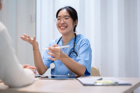 Photo for An Asian female doctor is giving advice and talking with a patient in the office, working at the hospital. healthcare concept - Royalty Free Image