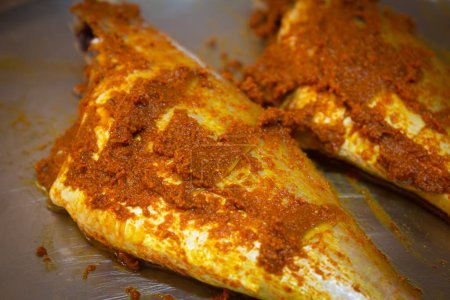 Photo for Red snapper fish marinated with spice mix and ready for oil fry or grilling. - Royalty Free Image