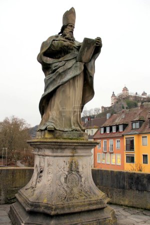Photo for St. Bruno statue on the Old Main Bridge, Alte Mainbruecke, Marienberg Fortress on a hill in the background, Wurzburg, Germany - January 26, 2023 - Royalty Free Image