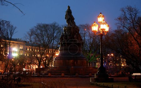 Photo for Monument to Catherine II, opened in 1873, statue of Catherine the Great, silhouette viewed at night, illuminated Nevsky Prospekt in the background, St. Petersburg, Russia - April 25, 2012 - Royalty Free Image