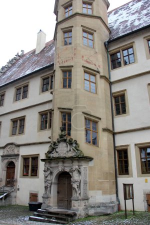 Photo for Staircase tower with sundial and sculptured portal of the renaissance building of the Old Gymnasium, at Kirchplatz 13, built in 1589, Rothenburg ob der Tauber, Germany - February 6, 2023 - Royalty Free Image