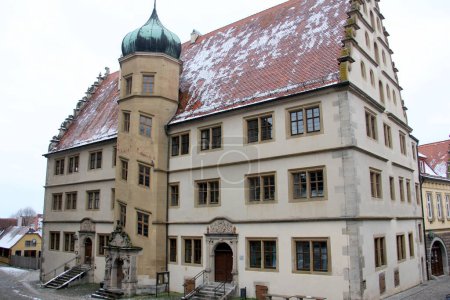 Photo for Renaissance building of the Old Gymnasium, at Kirchplatz 13, built in 1589, with staircase tower and onion dome, Rothenburg ob der Tauber, Germany - February 6, 2023 - Royalty Free Image