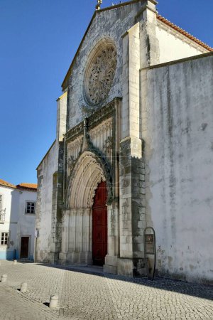 Photo for Church of the Grace, built between the 14th and 15th centuries in Gothic style, main portal with the rose window, Santarem, Portugal - November 21, 2023 - Royalty Free Image