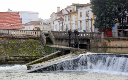 Lock on the dam by The Old Bridge, Ponte Velha, over Nabanus River, in the old town, Tomar, Portugal - February 6, 2024